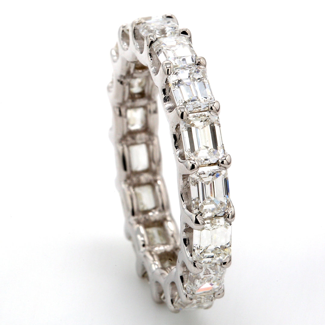 East to west style eternity band with shared U-prong set (17) emerald cut diamonds.  D4.10ct.t.w.