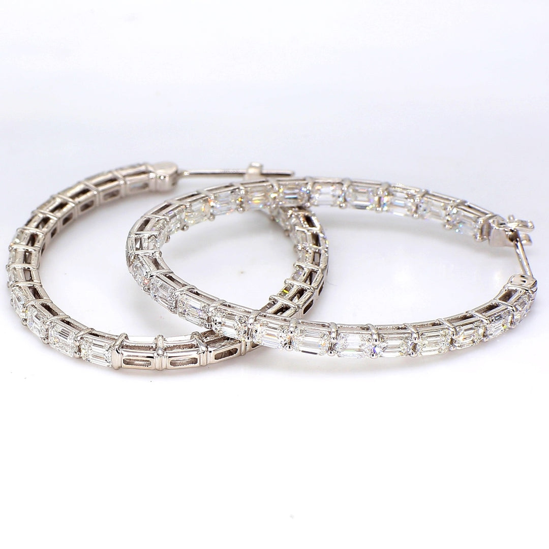 1.75"" Inside out oval shaped hoop earrings in 18K WG with shared prong set emerald cut diamonds.  D8.47ct.t.w.