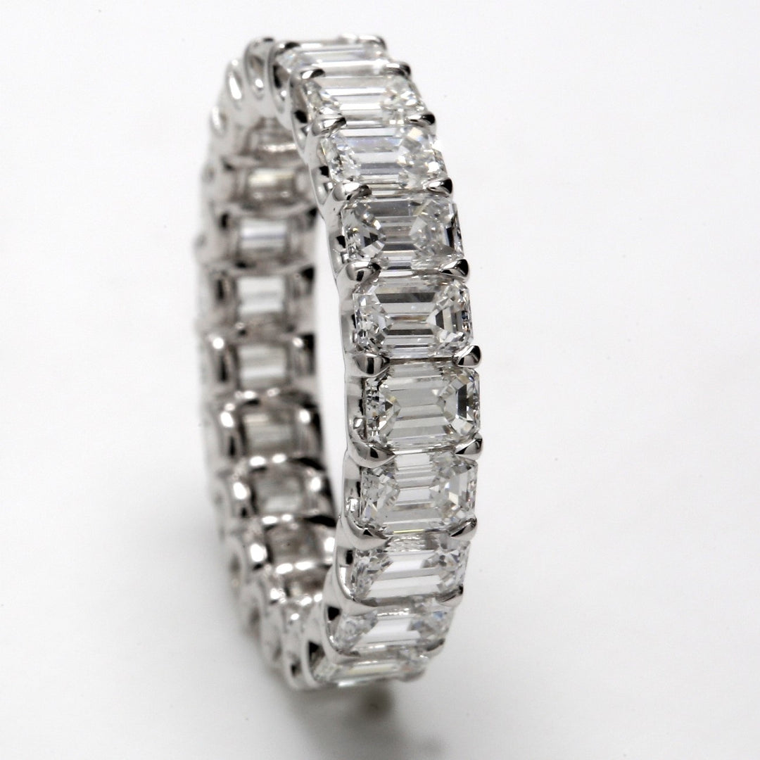 Eternity band in platinum with U-prong set (23) emerald cut diamonds.  D4.41ct.t.w.  Size 6