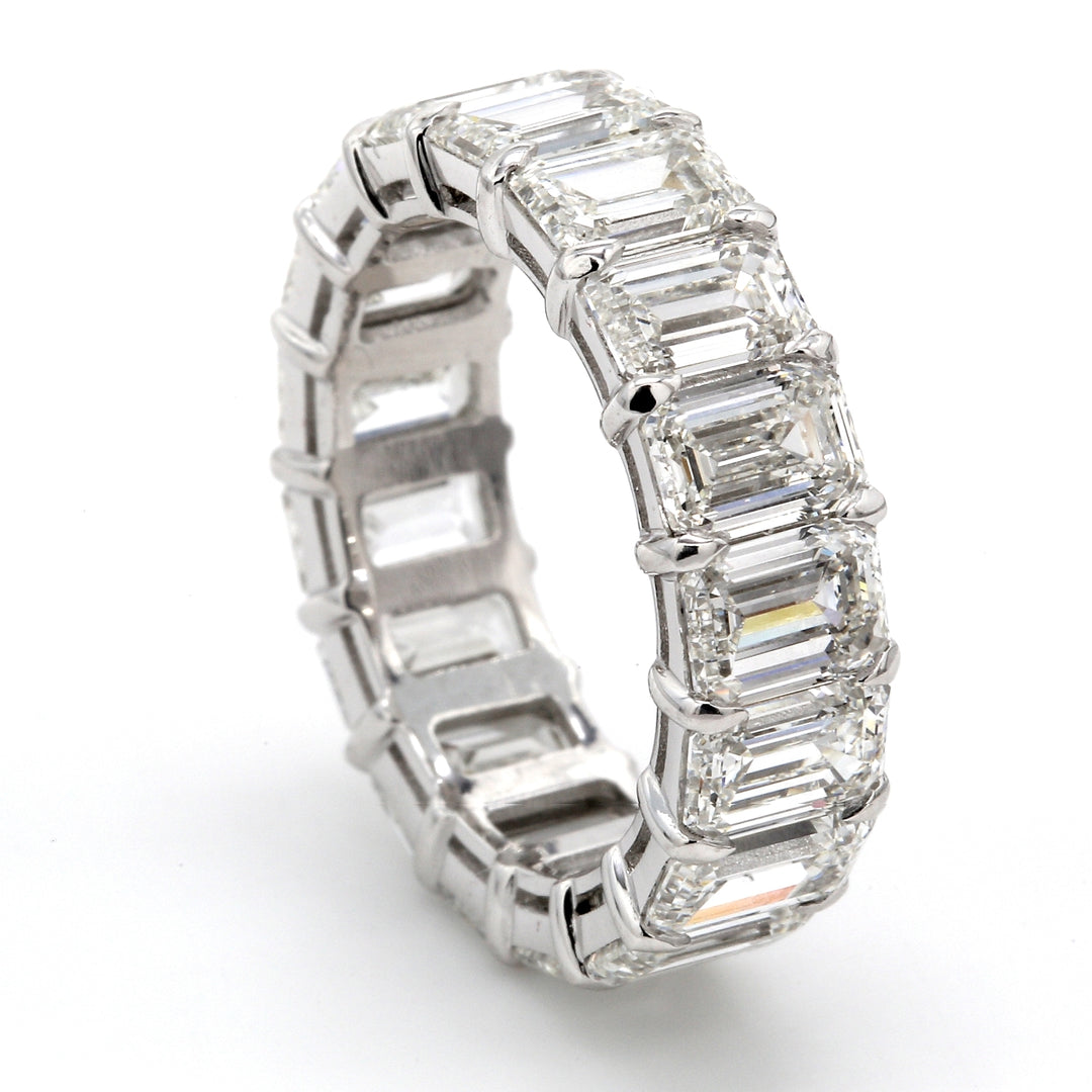 Eternity band in platinum with 4-prong basket set GIA certified G-H/VVS1-VS2 (17) emerald cut diamonds.  D9.08ct.t.w.  Size 6.25