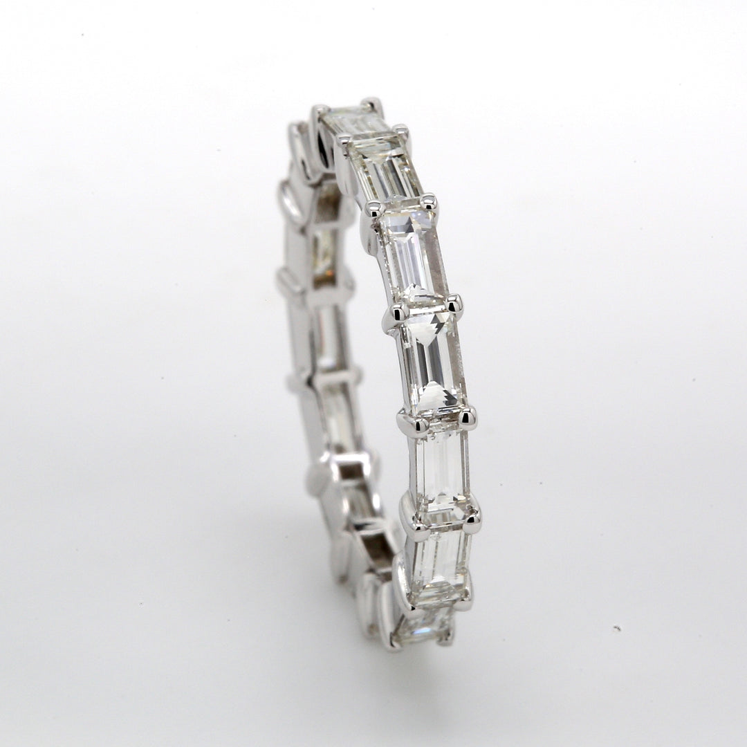 East to west style eternity band in 18K WG with shared prong set (15) baguette diamonds.  D1.75ct.t.w.  Size 4.75