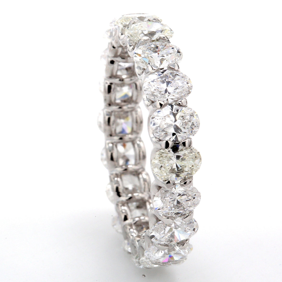 Eternity band in platinum with shared U-prong set (20) oval diamonds.  D4.40ct.t.w.  Size 7