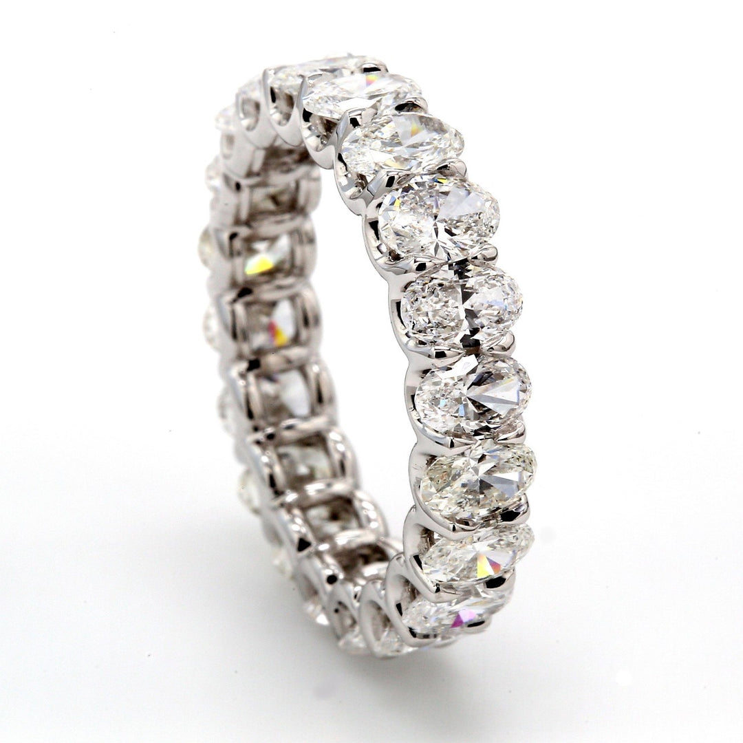 Eternity band in platinum with shared U-prong set (18) oval cut diamonds.  D5.49ct.t.w.  Size 7