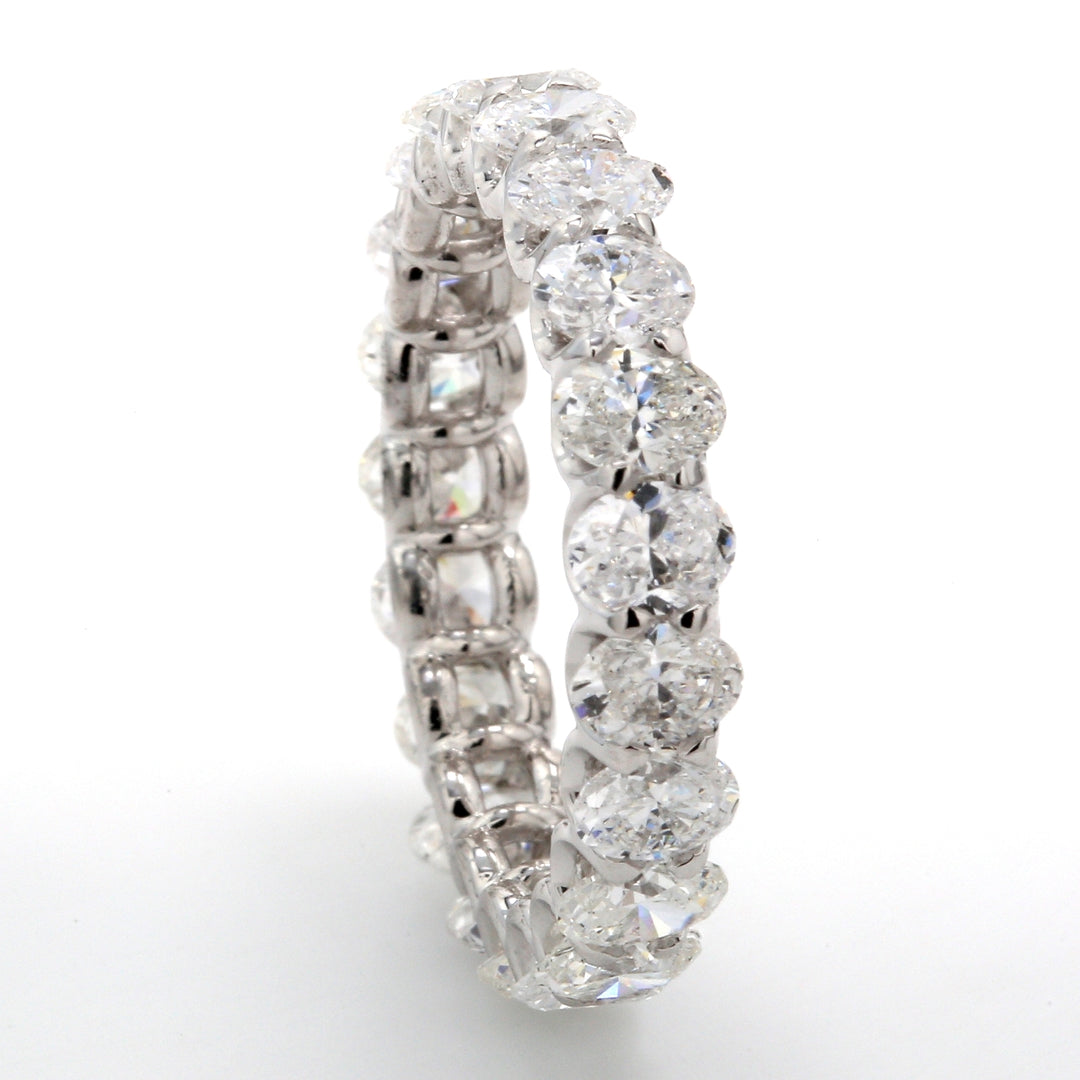 Eternity band in platinum with shared U-prong set (21) oval cut diamonds.  D3.20ct.t.w.  Size 6