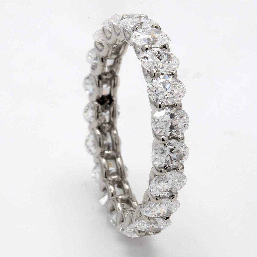 Eternity band in platinum with shared U-prong set (21) oval cut diamonds.  D2.98ct.t.w.  Size 6