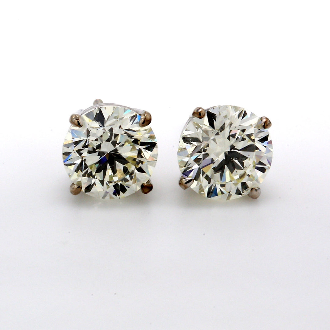 Screw back stud earrings with basket 4-prong set USA certified E/SI3-I1 round diamonds.  D2.01ct.t.w.