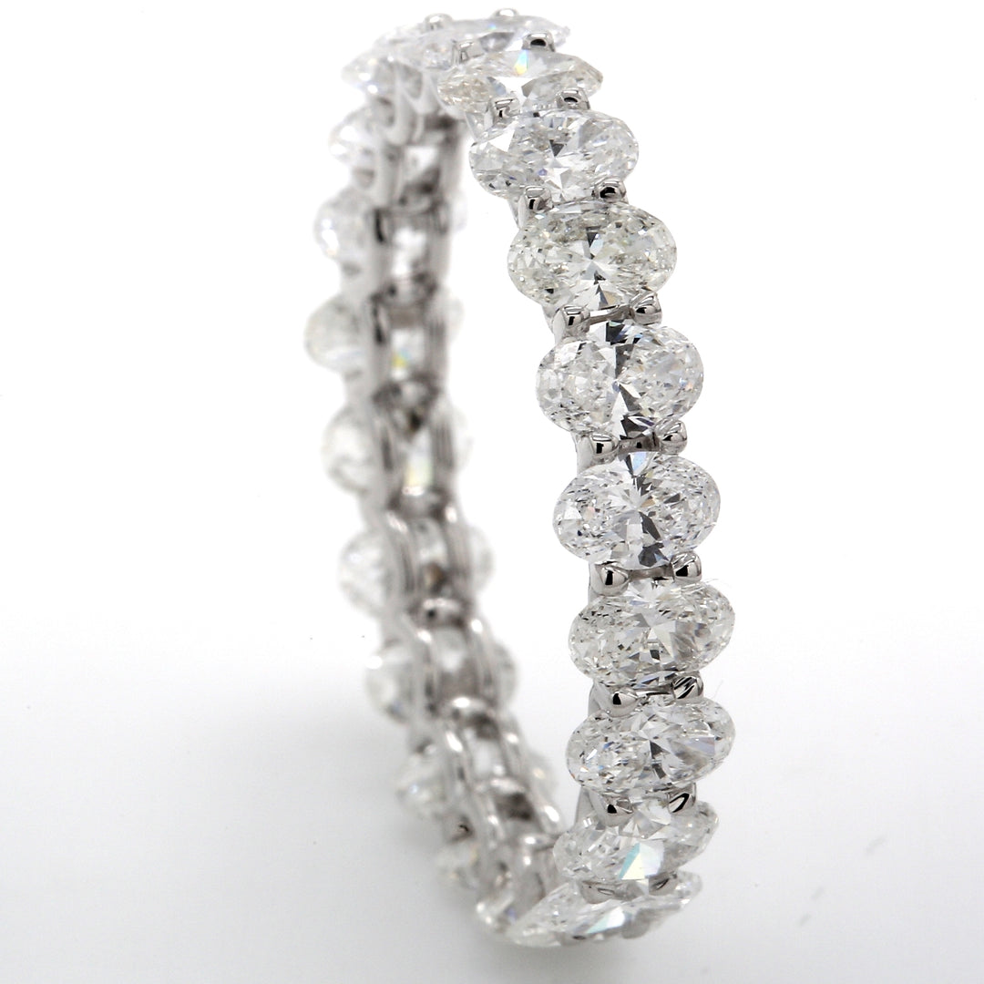 Eternity band with shared U-prong set D-E/VVS (22) oval cut diamonds.  D4.42ct.t.w.  Size 10.25