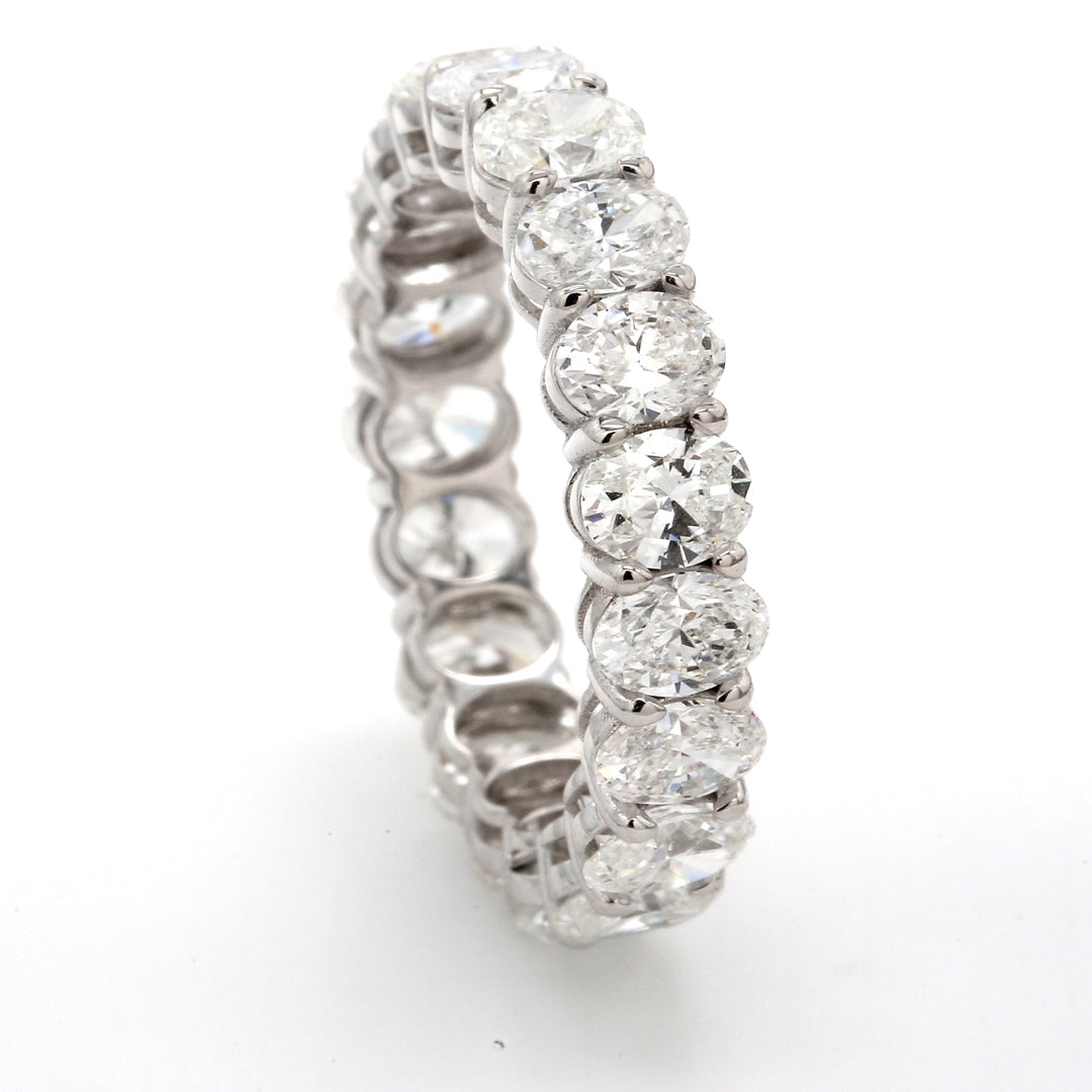 Eternity band in 18K WG with shared prong basket set (19) oval cut diamonds.  D4.52ct.t.w.  Size 6.5