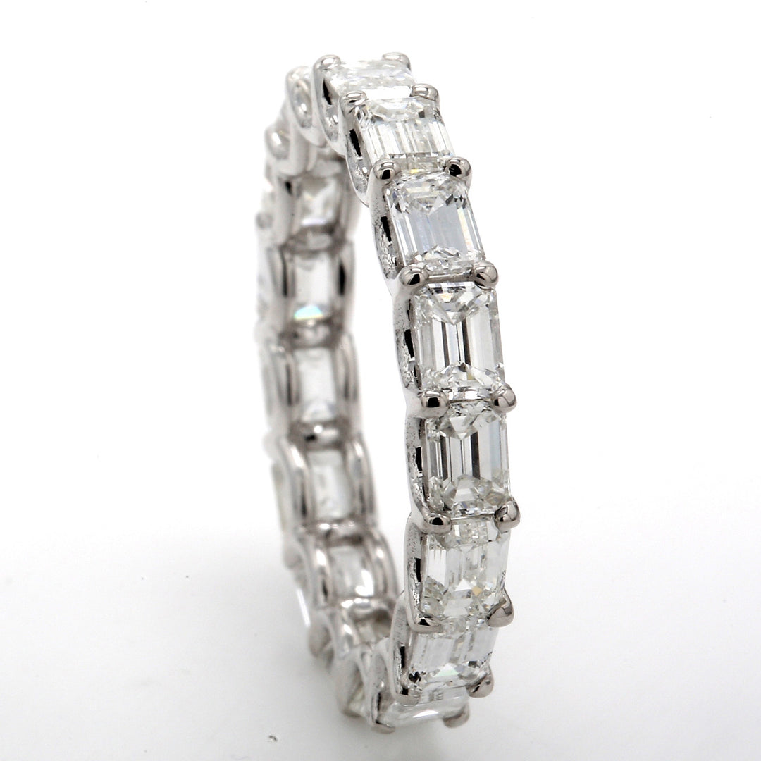 East to west eternity band in 18K WG with U-prong set (17) emerald cut diamonds.  D3.35ct.t.w.  Size 6