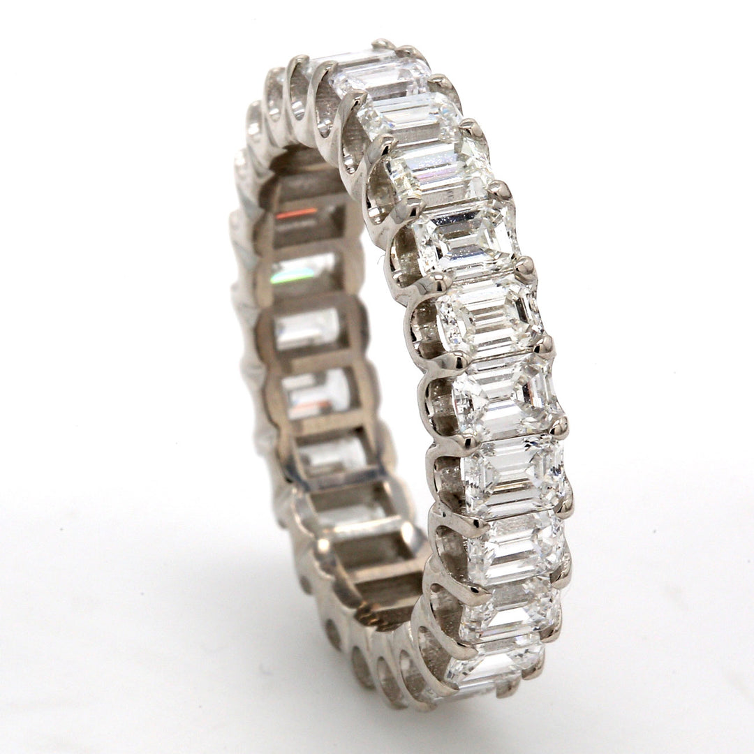 Eternity band in platinum with U-prong set (25) emerald cut diamonds.  D3.79ct.t.w.  Size 6.5