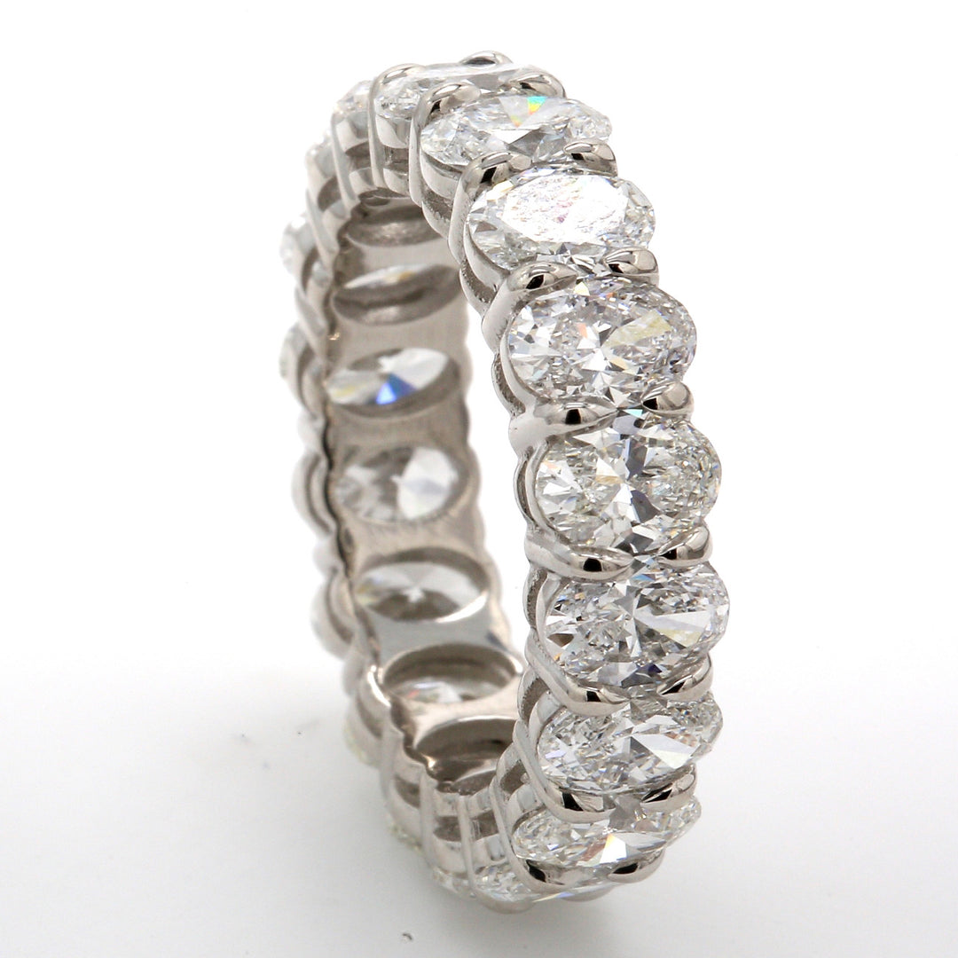 Eternity band in platinum with basket prong set (18) oval diamonds.  D5.49ct.t.w.  Size 6