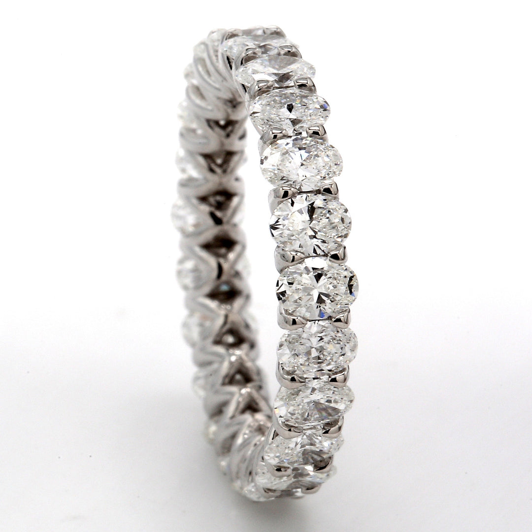 Eternity band in 18K WG with shared U-prong set (23) oval cut diamonds.  D3.18ct.t.w.  Size 6