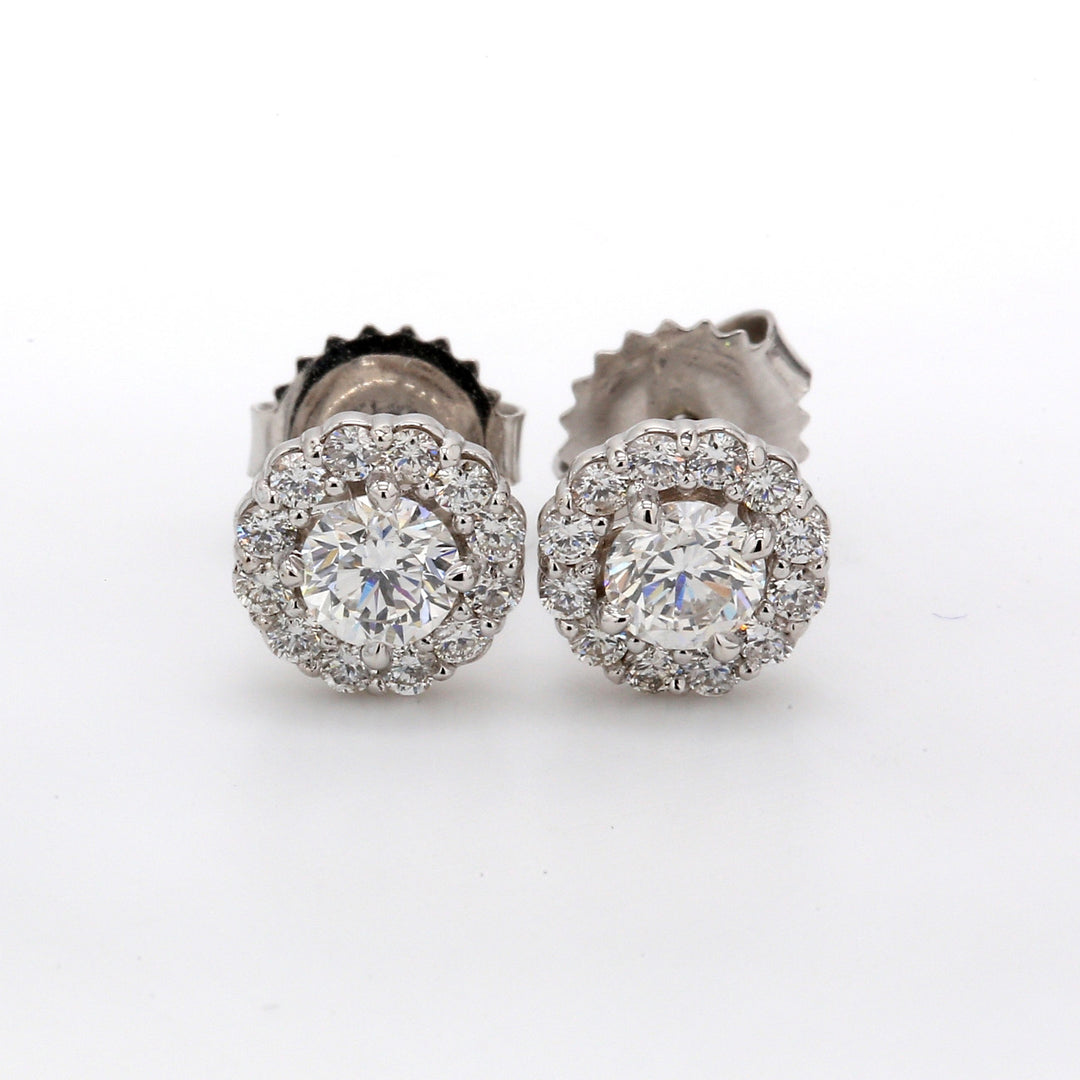 Push back halo stud earrings with prong set round diamonds.  D0.97ct.t.w.