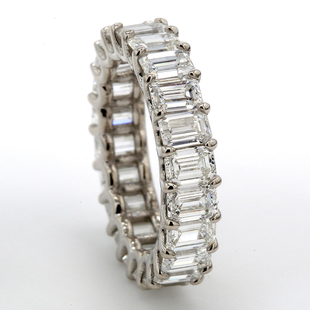 Eternity band in platinum with U-prong set (22) emerald cut diamonds.  D5.25ct.t.w.  Size 5