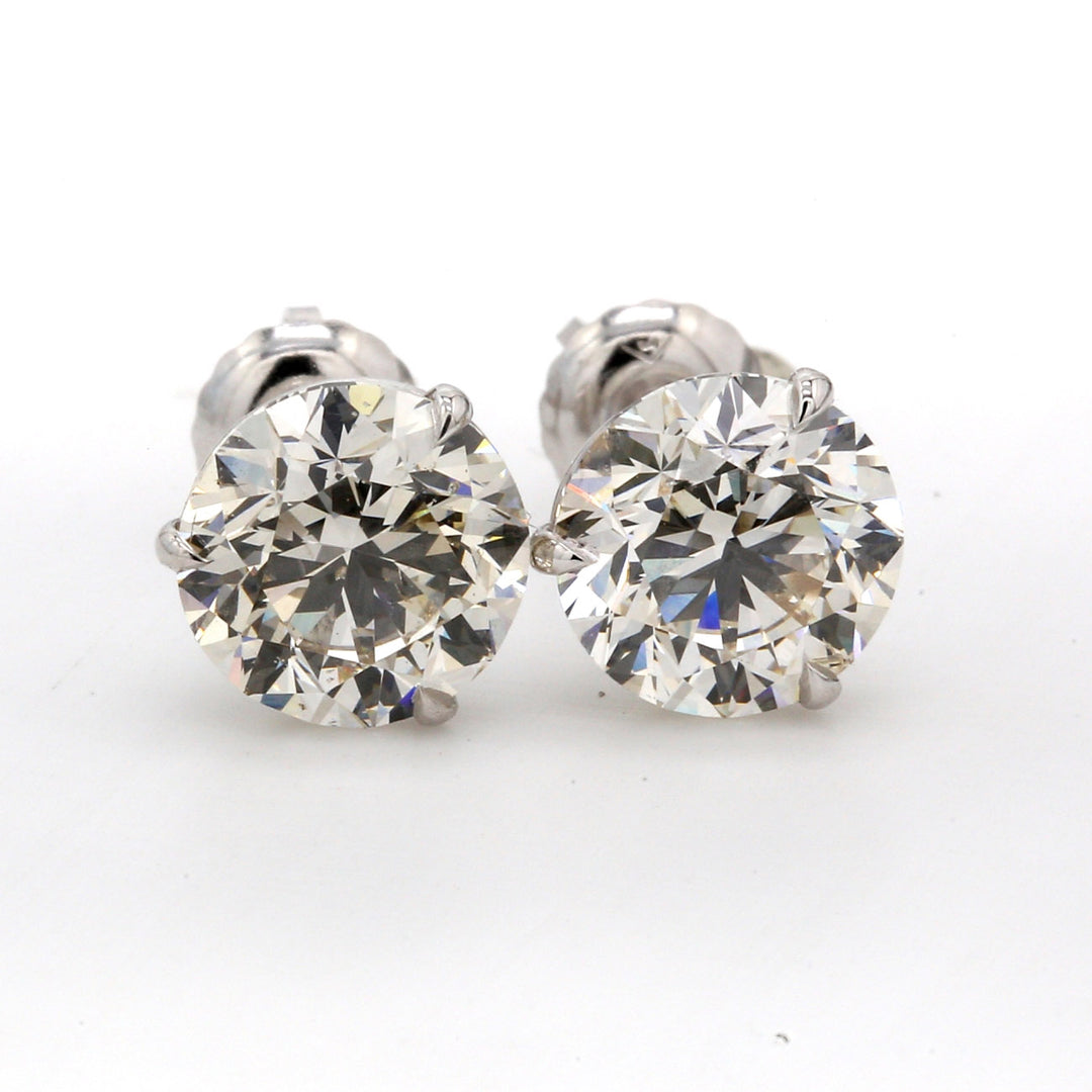 Screw back martini style stud earrings with prong set round diamonds.  D4.03ct.t.w.