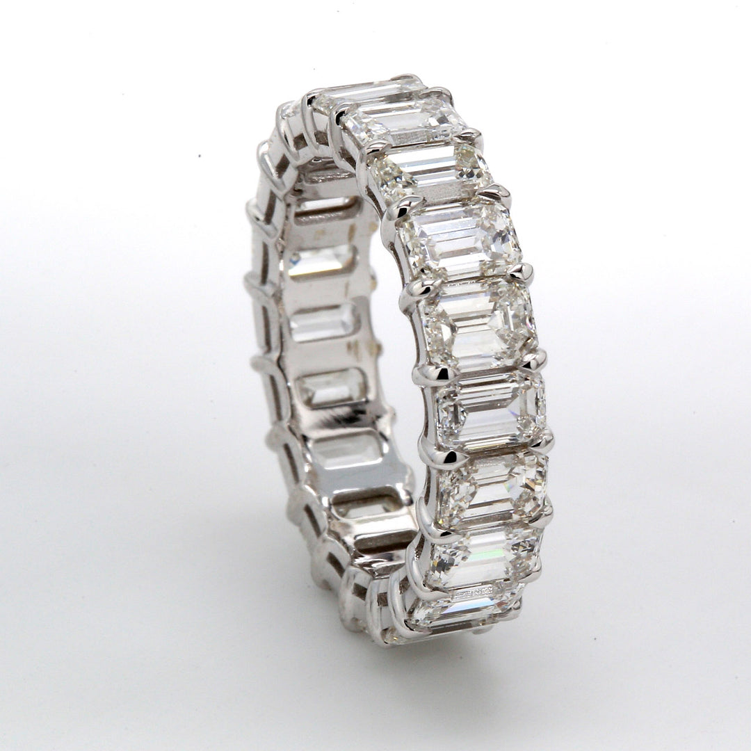Eternity band in 18K WG with basket claw prong set (20) emerald cut diamonds.  D5.23ct.t.w.  Size 5.5
