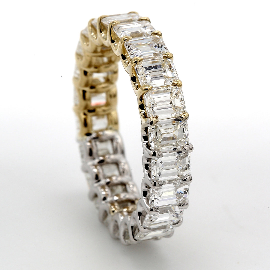 Eternity band in half yellow gold and whitegold with u-prong set (22) emerald cut diamonds.  D6.02ct.t.w.  Size 6.75