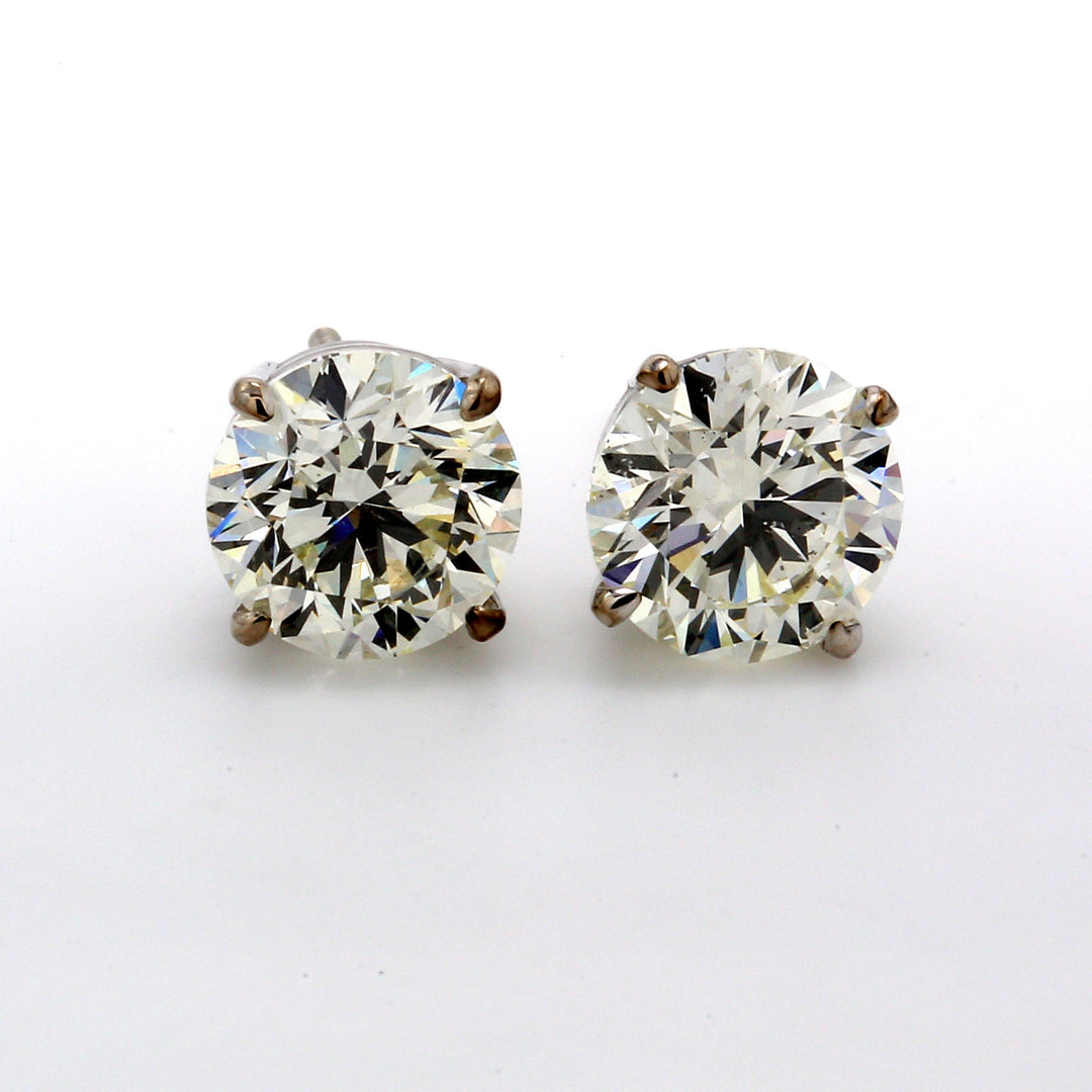 Screw back stud earrings with eagle claw prong set round diamonds.  D3.01ct.t.w.