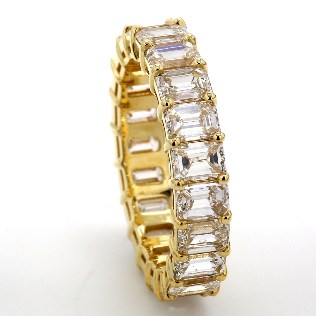 Eternity band in 18K YG with basket claw set (21) emerald cut diamonds.  D5.02ct.t.w.  Size 6.25
