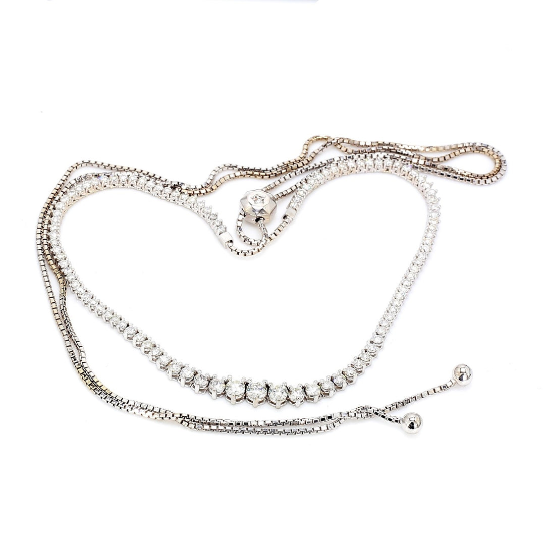 Bolo style graduating tennis necklace with prong set (78) round diamonds.  D5.17ct.t.w.