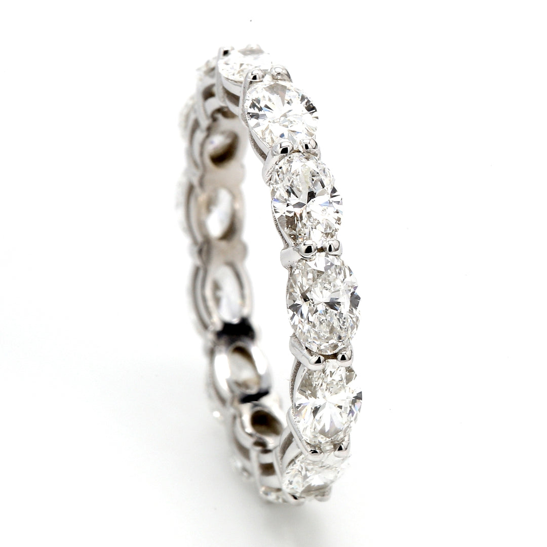 East to west style eternity band in 18K WG with shared prong set oval diamonds.  D2.38ct.t.w.  Size 4.75
