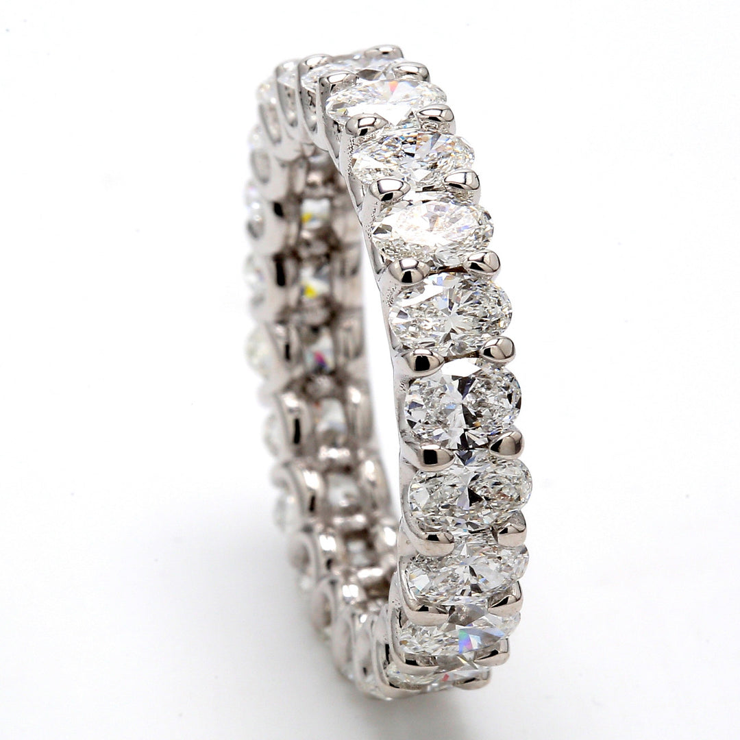 Eternity band in platinum shared U-prong set (22) oval diamonds.  D3.11ct.t.w.  Size 5