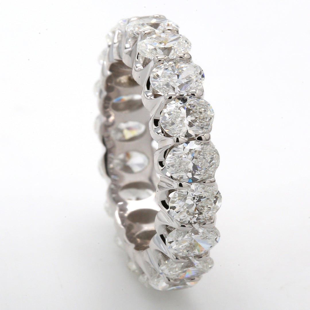 Eternity band in 18K WG with shared U-prong set (19) oval diamonds.  D4.68ct.t.w.  Size 5.75