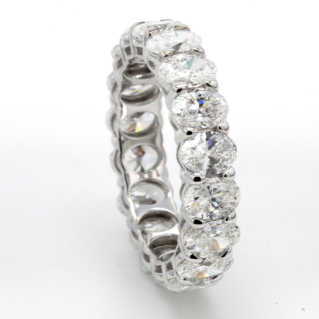 Eternity band in 18K WG with shared basket prong set (18) oval diamonds.  D4.38ct.t.w.  Size 6