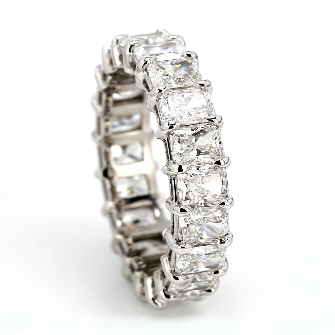 Eternity band in platinum with shared prong set radiant cut diamonds.  D5.27ct.t.w.