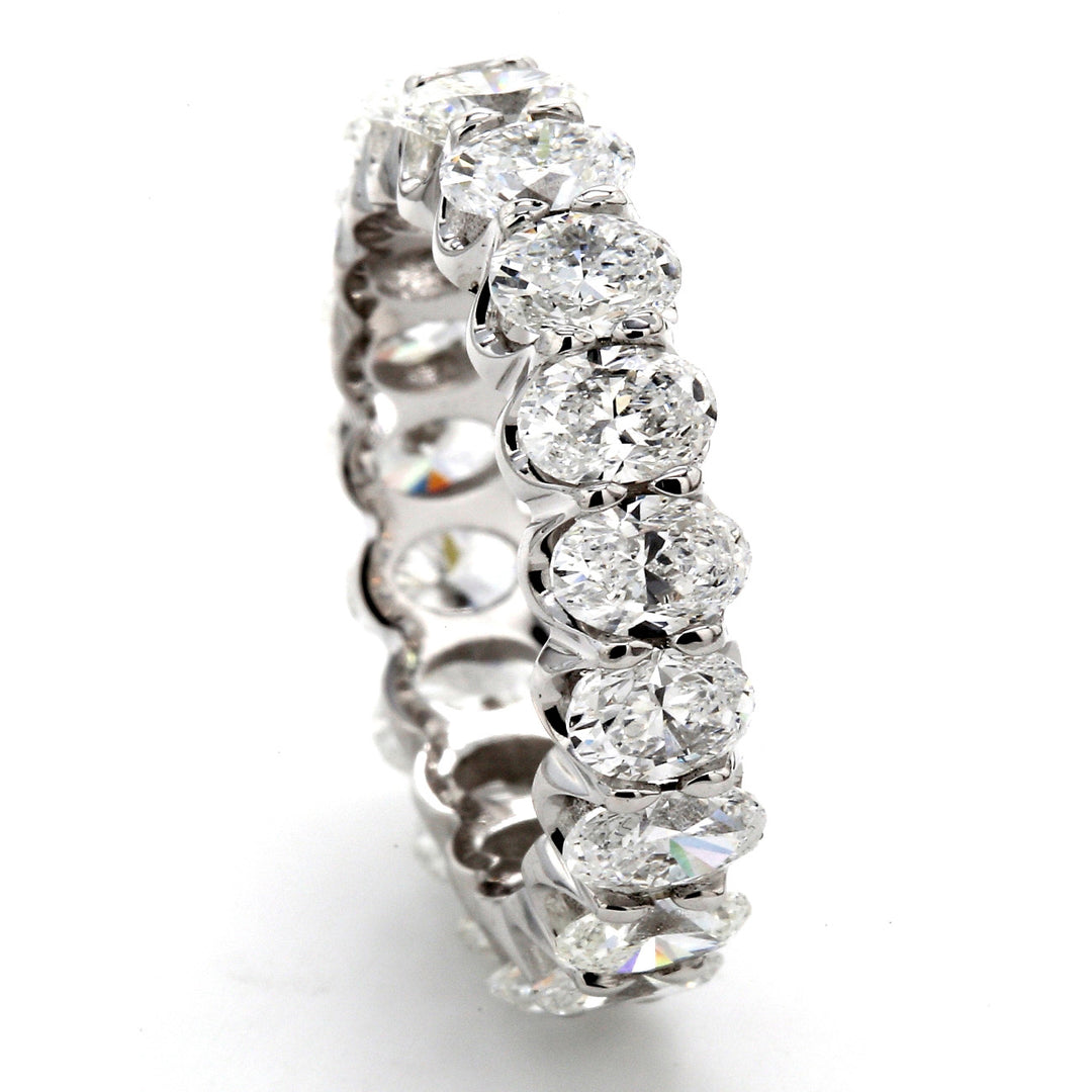 Eternity band in platinum with shared U-prong set (19) oval diamonds.  D4.53ct.t.w.  Size 6