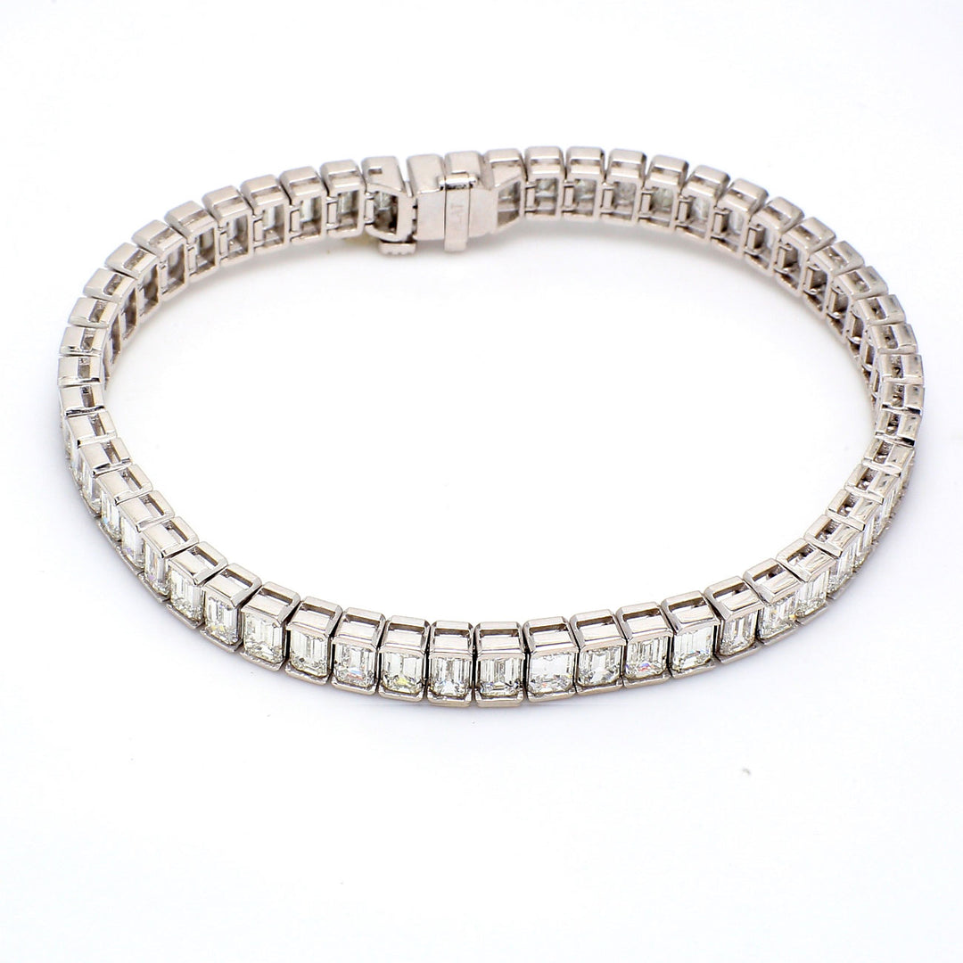7"" Tennis bracelet in platinum with half bezel set (55) emerald cut diamonds.  D13.45ct.t.w.