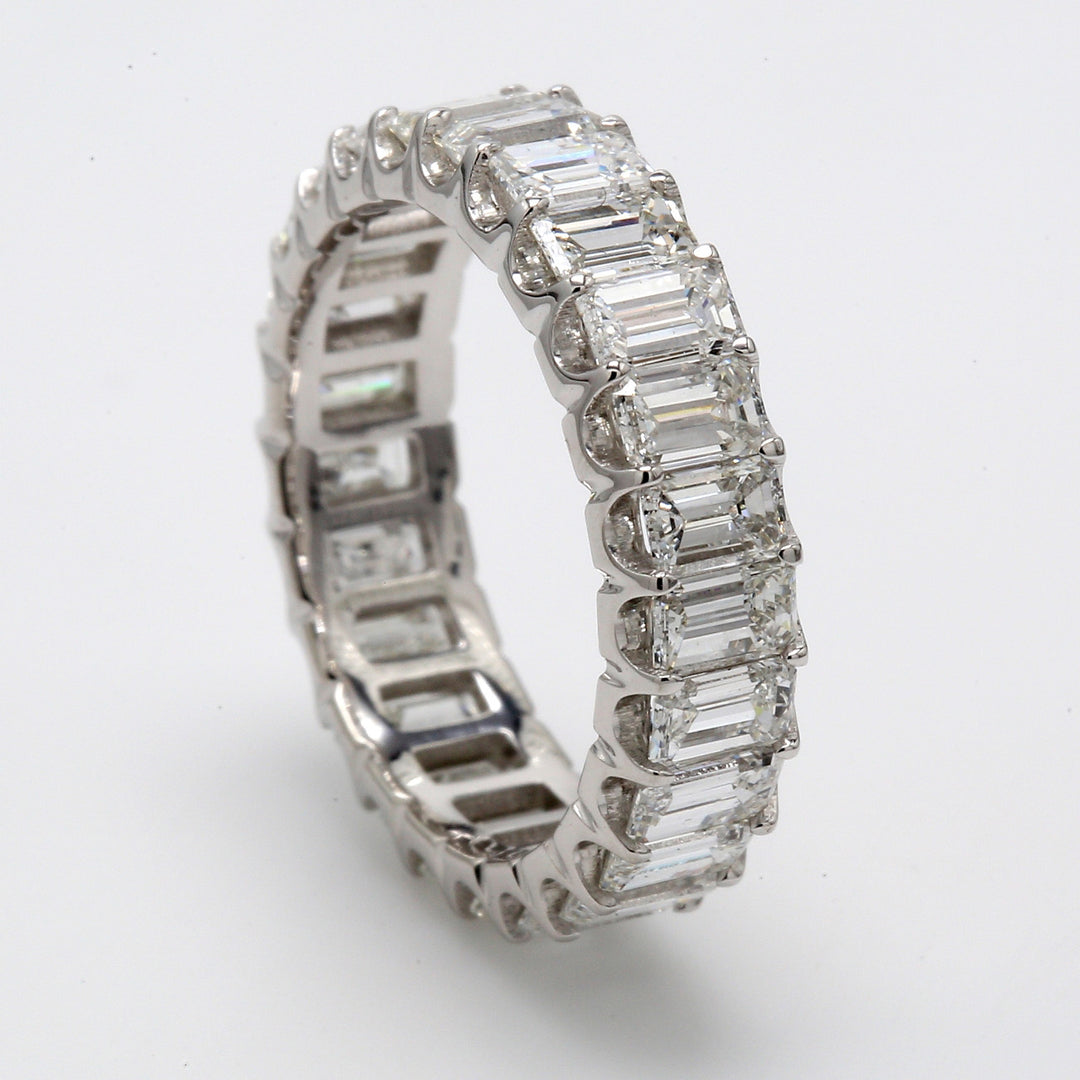 Eternity band in platinum with shared U-prong set (25) emerald cut diamonds.  D3.59ct.t.w.  Size 5