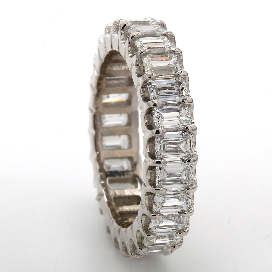 Eternity band in platinum with shared U-prong set (25) emerald cut diamonds.  D4.11ct.t.w.  Size 7