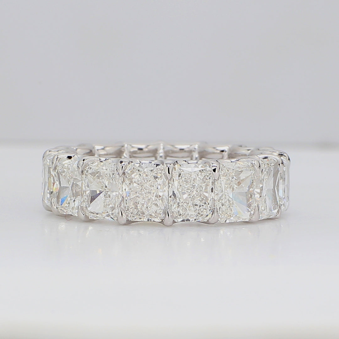 Eternity band in platinum with claw U-prong set GIA certified E-G/SI1 (16) radiant cut diamonds.  D11.47ct.tw.  Size 7.5