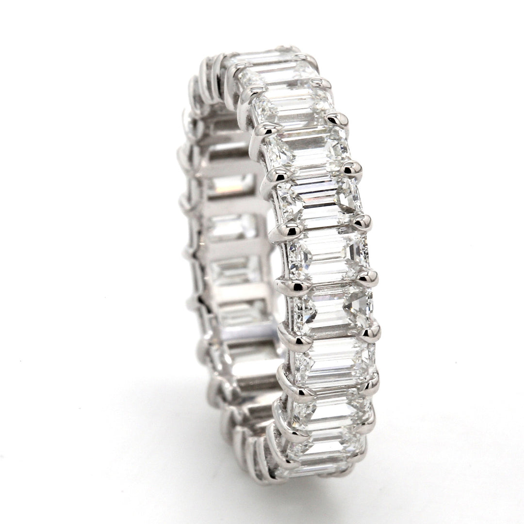 Eternity band in 18K WG with shared prong set (24) emerald cut diamonds.  D3.38ct.t.w.  Size 5.5