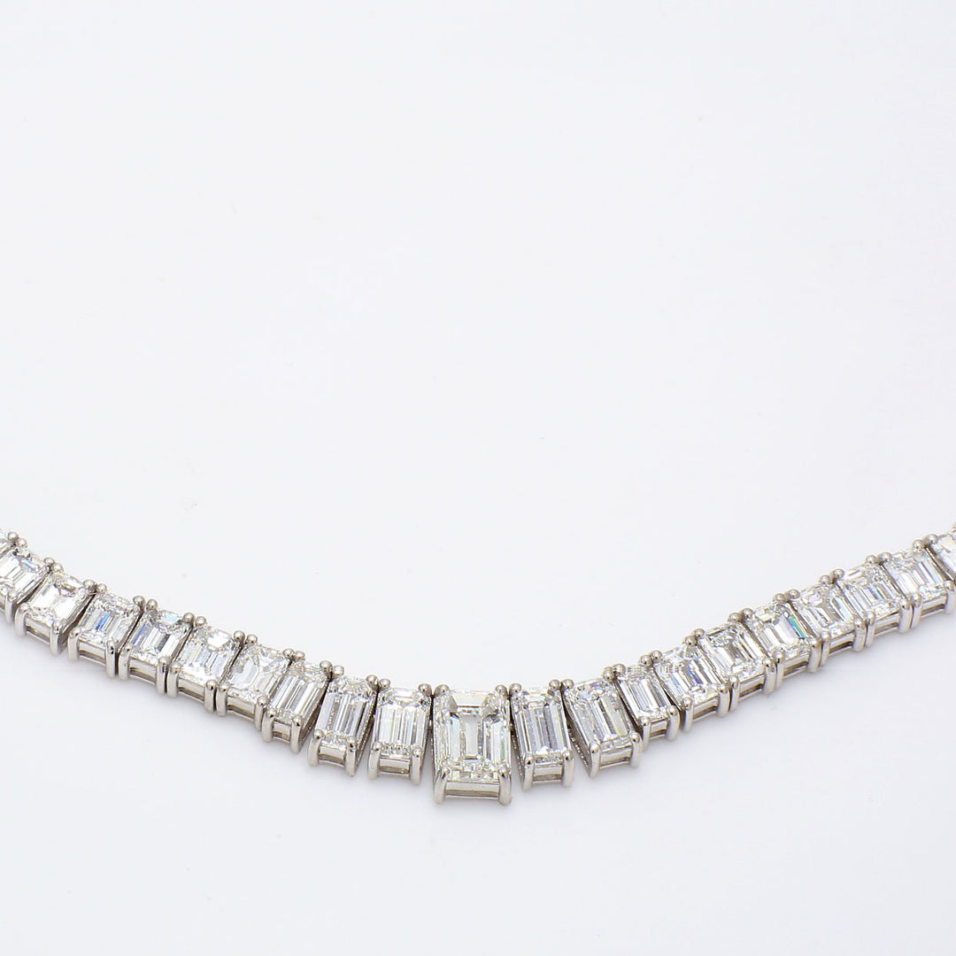 17.5"" Graduated tennis necklace in platinum with basket prong set G+/VS+ emerald cut diamonds.  D33.08ct.t.w.  (Center 1.70ct.)