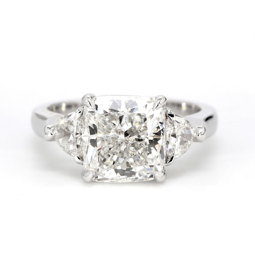 3-stone ring in Platinum with claw set GIA certified G/VS2 cushion cut center and 3-prong set half moon diamond sides.  D4.32ct.t.w.  (Center 3.79ct.)  Size 6