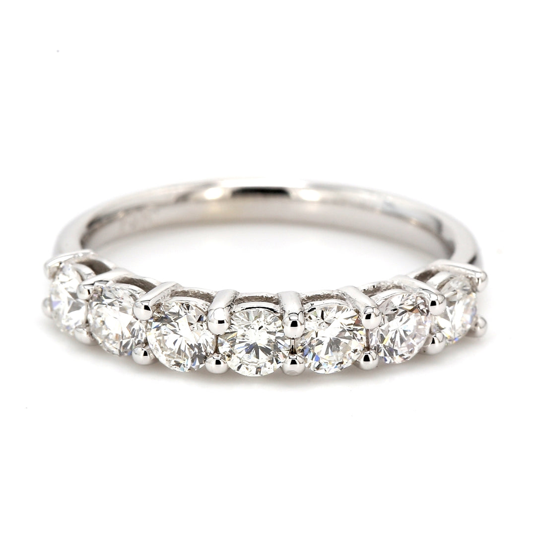 7-stone band with shared basket prong set round diamonds.  D1.06ct.t.w.  Size 7