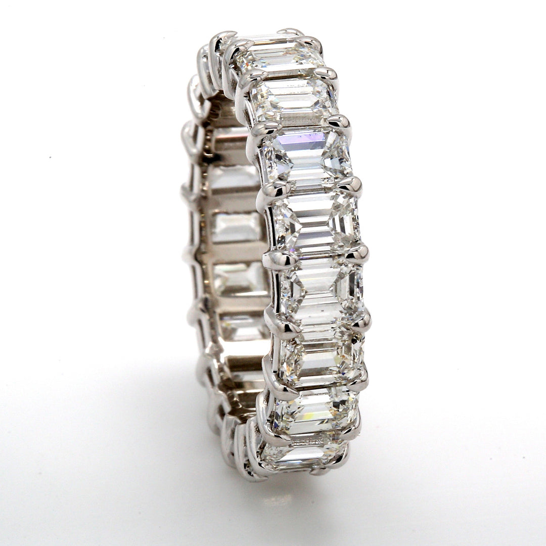 Eternity band in platinum with prong basket set (20) emerald cut diamonds.  D5.04ct.t.w.  Size 5.5