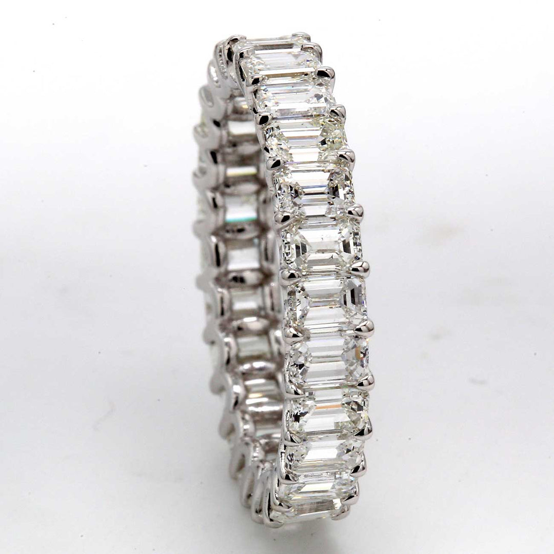 Eternity band in 18K WG with shared U-prong set (26) emerald cut diamonds.  D3.91ct.t.w.  Size 7.25