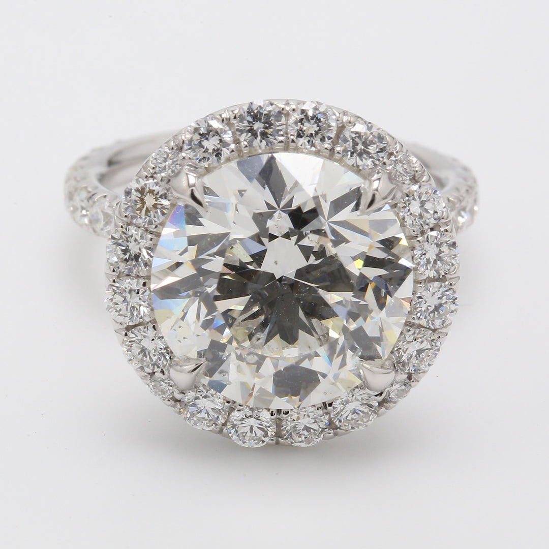 Halo ring in platinum with prong set rounds around GIA certified J/SI1 round diamond centerstone.  D8.79ct.t.w.  (Center 7.01ct.)