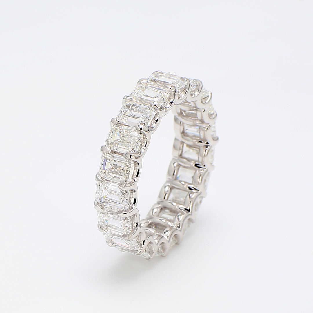 Eternity band in platinum with shared claw U-prong set GIA certified D-F/VVS2-VS2 (19) emerald cut diamonds.  D7.96ct.t.w.  Size 7