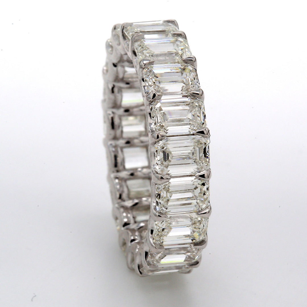 Eternity band in platinum with claw U-prong et (19) emerald cut diamonds.  D6.12ct.t.w.  Size 5.5