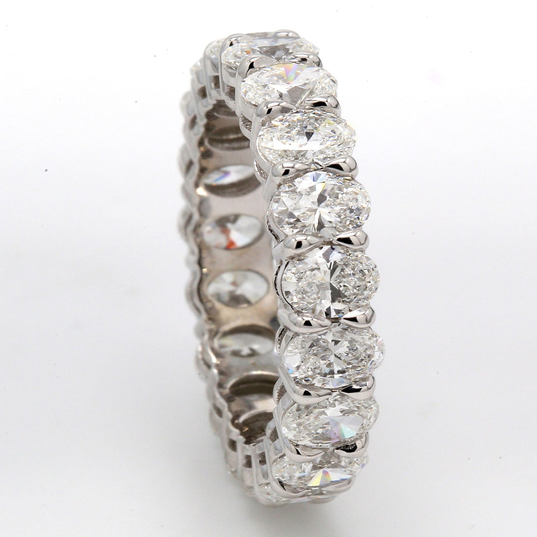 Eternity band in platinum with basket shared prong set (19) oval diamonds.  D4.70ct.t.w.  Size 6.75