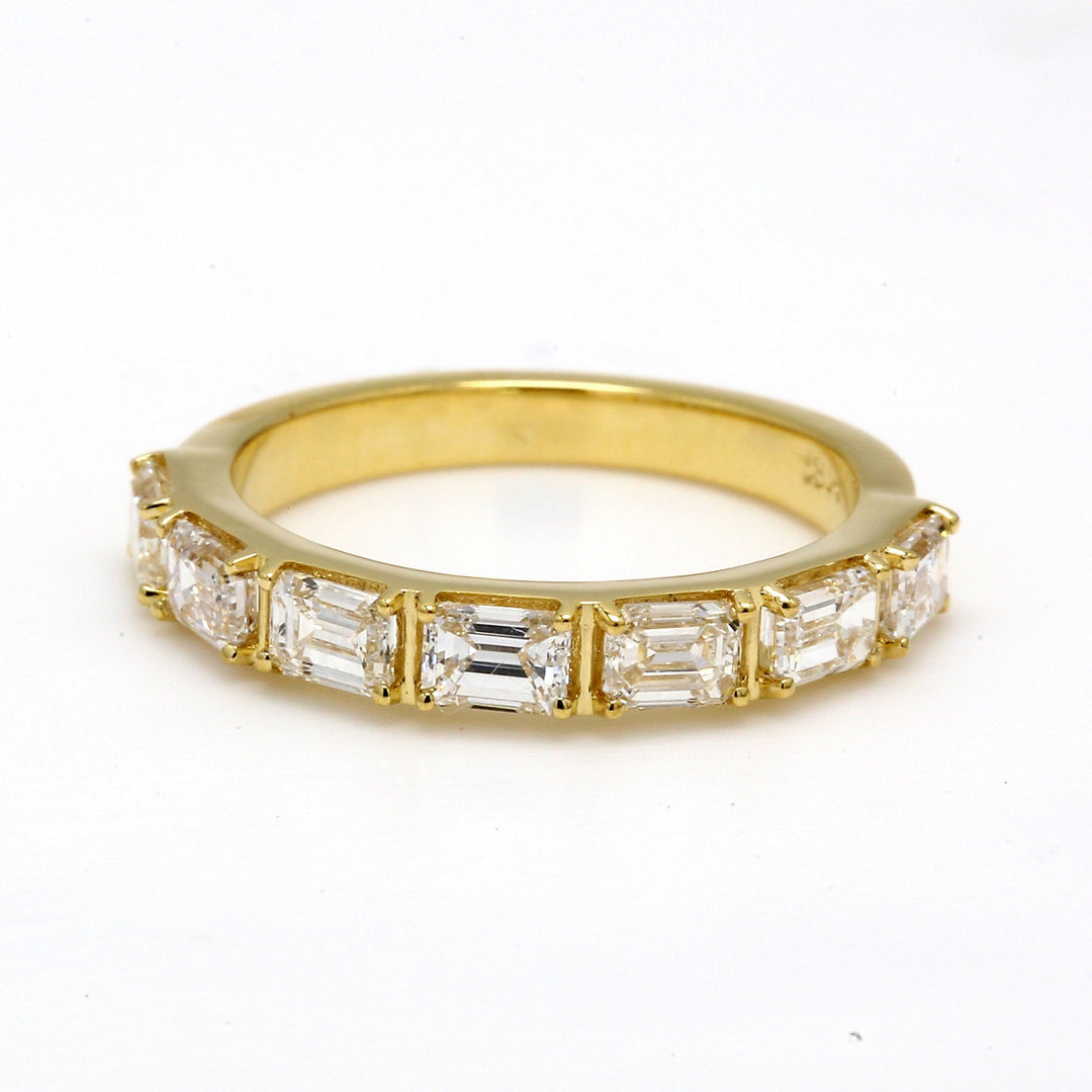 7-stone band in 18K YG with prong set emerald cut diamonds.  D1.33ct.t.w.  Size 5.5