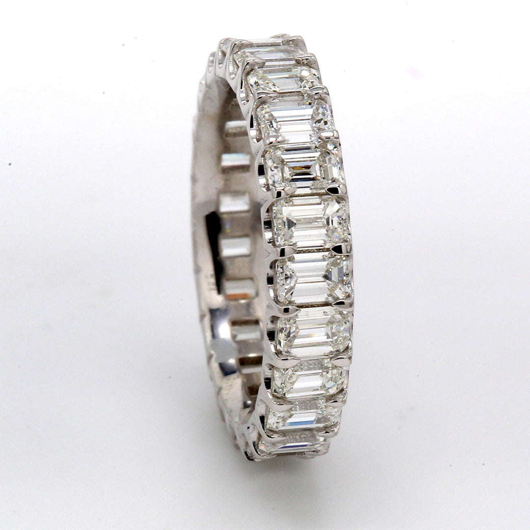 Eternity band in platinum with shared U-prong set (23) emerald cut diamonds.  D3.57ct.t.w.  Size 5