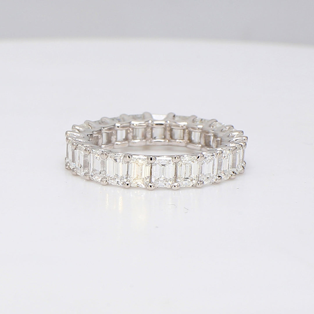 Eternity band in platinum with U-prong set (23) emerald cut diamonds.  D4.32ct.t.w.  Size 6.75