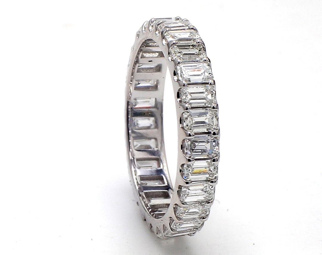 Eternity band in platinum with U-prong set (27) emerald cut diamonds.  D2.51ct.t.w.  Size 6