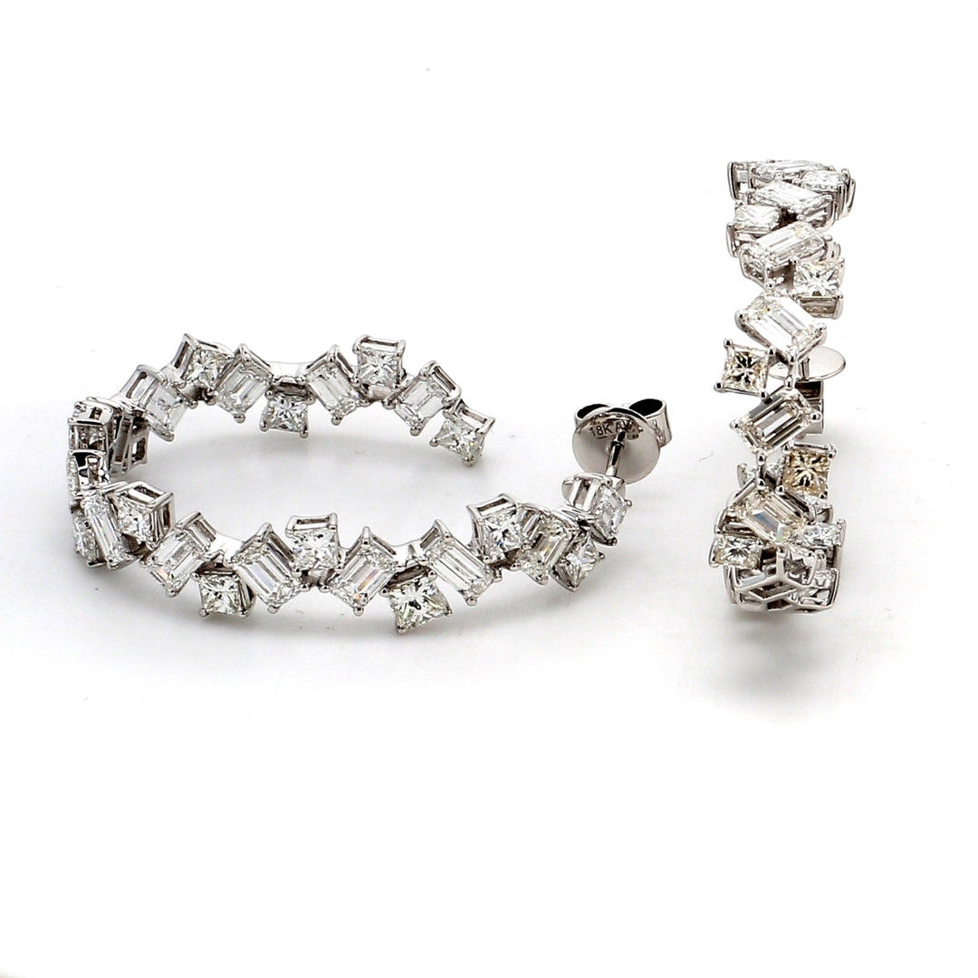 1.25"" Inside out hoop earrings in 18K WG with basket prong set (26) princess cuts and (26) emerald cut diamonds in free style shapes.  D10.14ct.t.w.
