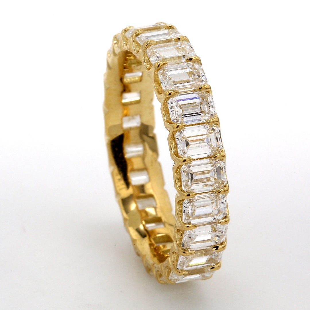 Eternity band in 18K YG with shared U-prong set (23) emerald cut diamonds.  D3.92ct.t.w.  Size 6